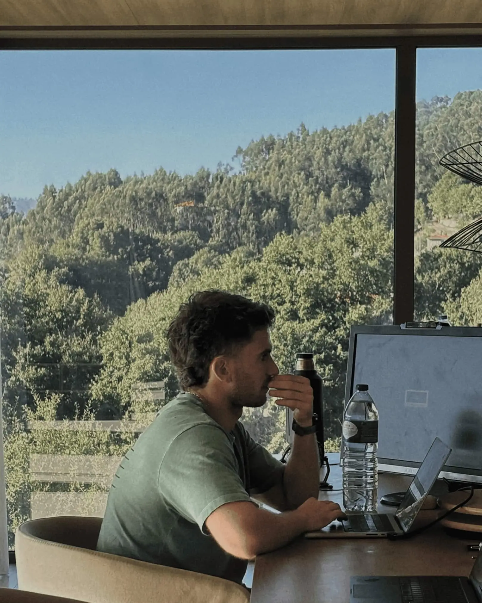 Quartz team member working beside a window overlooking the countryside